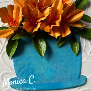 Up close to the Spellbinders Azalea and Garden Pot die set in flame with a blue pot