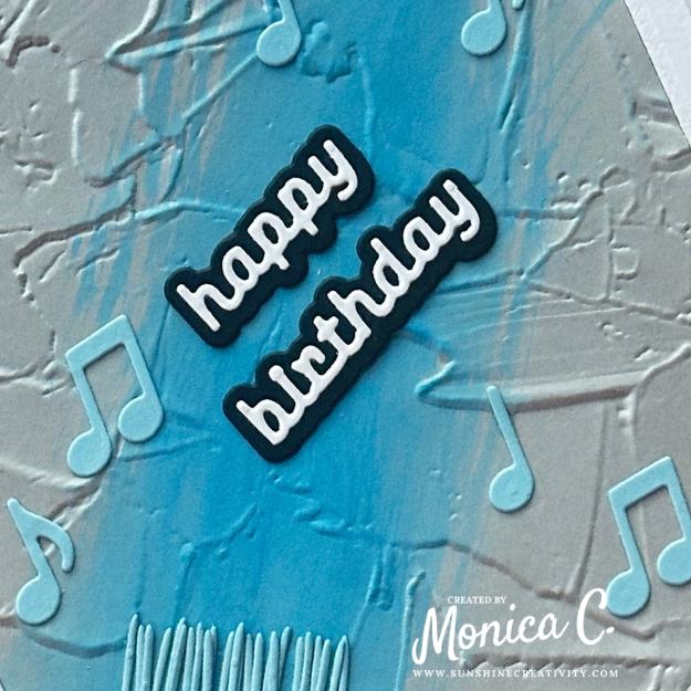 A close up of my masculine card with paint and music