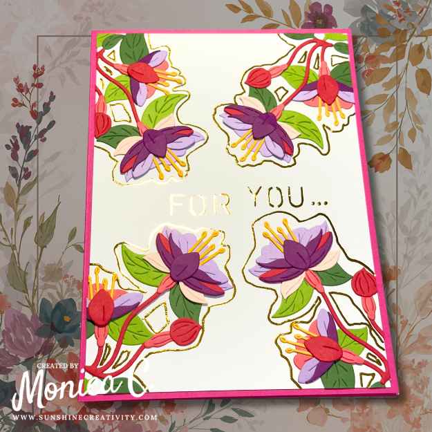 I tilted the card to catch the light on the foil around the magical fuchsia die cuts.