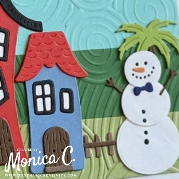 Showing off the snowman next to the Whimsical Houses